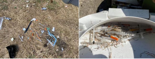 Picture of needles in the ground in Vancouver homeless camp.