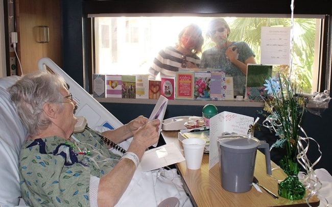Families visiting each other through windows. Will the loss of connection between loved ones be a worthy pandemic cost in the end?