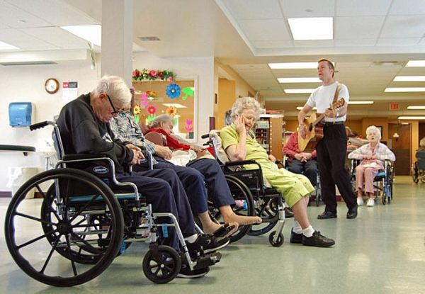 Guitarist entertaining residents of Canadian long-term care facility.